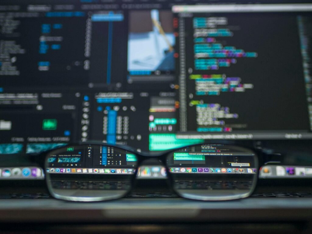 Development Eyeglasses reflecting computer code on a monitor, ideal for technology and programming themes.