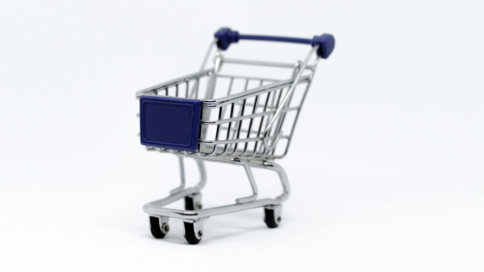 ecommerce A modern miniature shopping cart on a clean white background, perfect for e-commerce concepts.